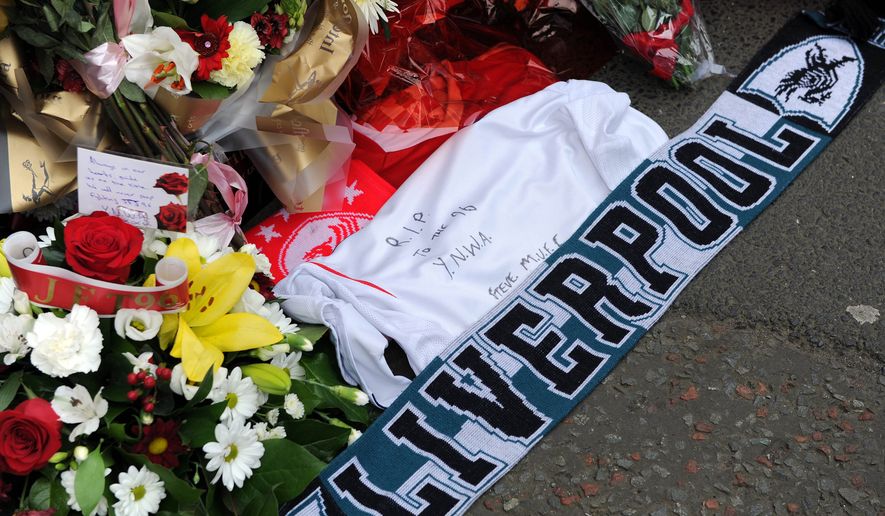 FILE -Tributes are laid at the memorial of the Hillsborough disaster outside Anfield before the English Premier League soccer match between Liverpool and Manchester City at Anfield in Liverpool, England, April. 13, 2014. (AP Photo/Clint Hughes, File)