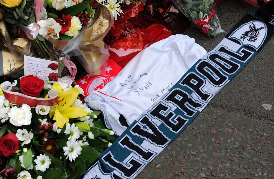 FILE -Tributes are laid at the memorial of the Hillsborough disaster outside Anfield before the English Premier League soccer match between Liverpool and Manchester City at Anfield in Liverpool, England, April. 13, 2014. (AP Photo/Clint Hughes, File)
