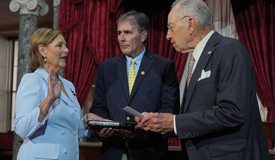 Darline Graham, sister of Sen. Lindsey Graham, R-S.C., is ceremonially sworn-in by President Pro Tempore of the Senate, Chuck Grassley, R-Iowa, in the Old Senate Chamber at the Capitol in Washington, Tuesday, July 14, 2026, as her husband Larry Nordone holds the Bible. (AP Photo/J. Scott Applewhite)