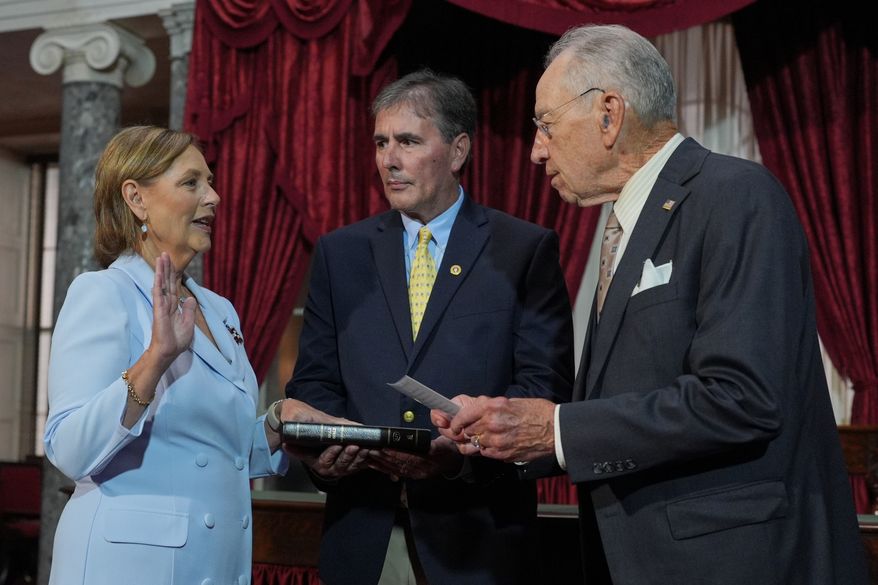 Darline Graham, sister of Sen. Lindsey Graham, R-S.C., is ceremonially sworn-in by President Pro Tempore of the Senate, Chuck Grassley, R-Iowa, in the Old Senate Chamber at the Capitol in Washington, Tuesday, July 14, 2026, as her husband Larry Nordone holds the Bible. (AP Photo/J. Scott Applewhite)