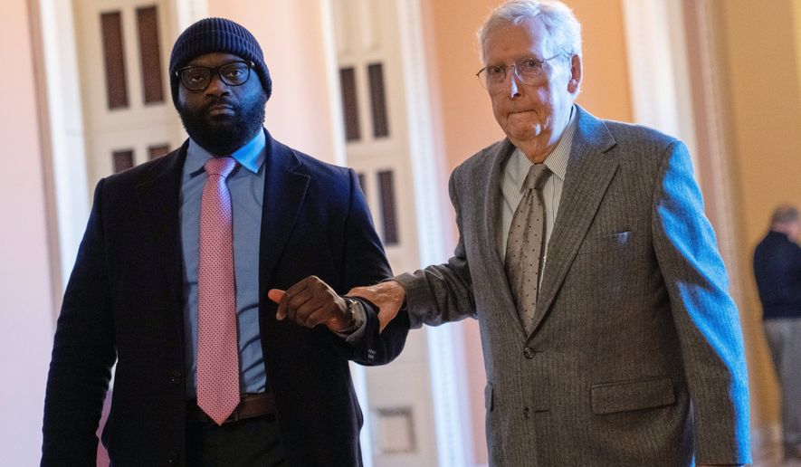 FILE - Sen. Mitch McConnell, R-Ky., right, walks through the Capitol, Jan. 15, 2026, in Washington. (AP Photo/Allison Robbert, File)