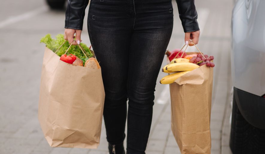 Groceries from a supermarket in paper bags. Paper eco bags full of fresh food. (Courtesy Studio113/Shutterstock)