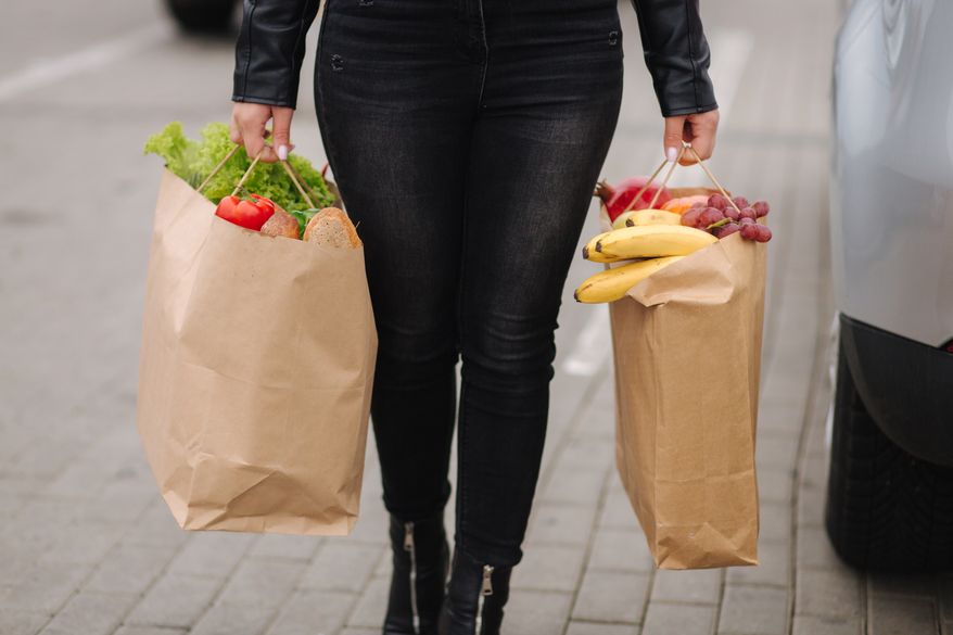 Groceries from a supermarket in paper bags. Paper eco bags full of fresh food. (Courtesy Studio113/Shutterstock)