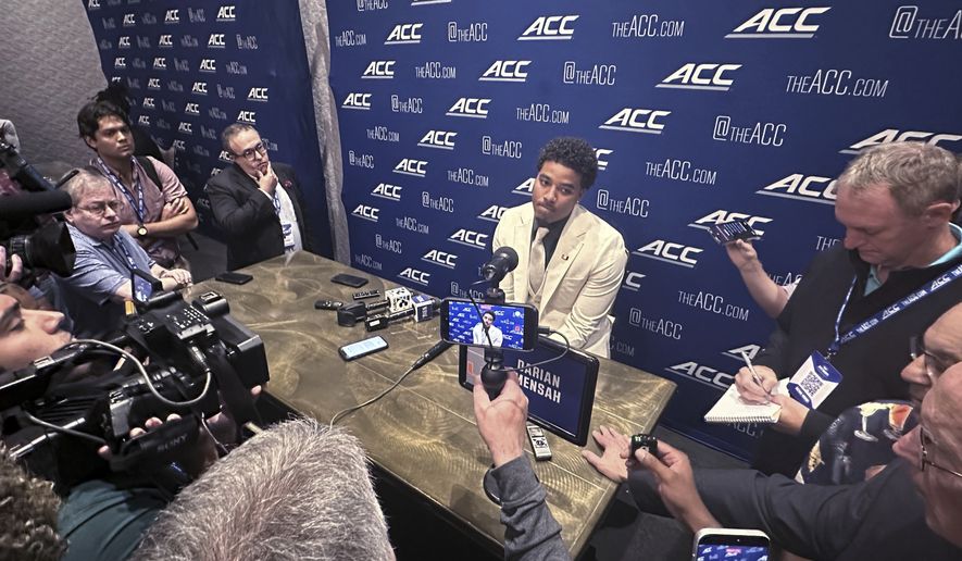 Miami quarterback Darian Mensah listens during ACC Kickoff preseason football media days, Wednesday, July 15, 2026 in Charlotte, N.C. (AP Photo/Aaron Beard)