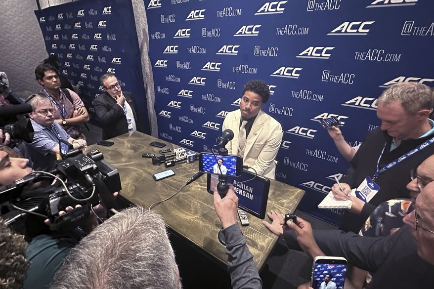 Miami quarterback Darian Mensah listens during ACC Kickoff preseason football media days, Wednesday, July 15, 2026 in Charlotte, N.C. (AP Photo/Aaron Beard)