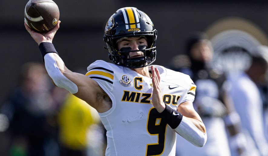 FILE - Missouri quarterback Beau Pribula (9) throws to a receiver during warmups before an NCAA college football game against Vanderbilt, Oct. 25, 2025, in Nashville, Tenn. (AP Photo/Wade Payne, File)