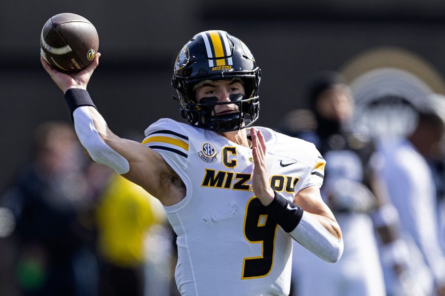FILE - Missouri quarterback Beau Pribula (9) throws to a receiver during warmups before an NCAA college football game against Vanderbilt, Oct. 25, 2025, in Nashville, Tenn. (AP Photo/Wade Payne, File)