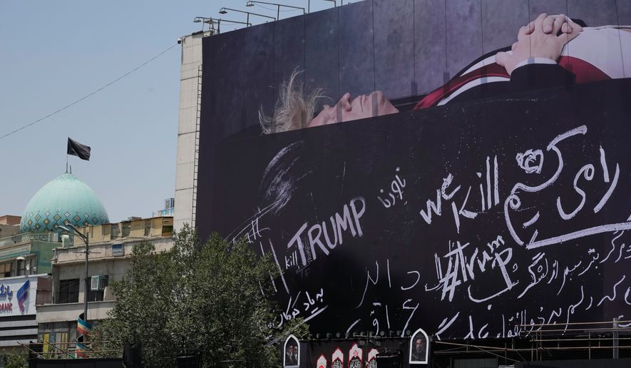 A billboard depicting U.S. President Donald Trump lying on what appears to be a coffin and bearing anti-Trump messages, including the phrase "We Kill Trump," is seen at Islamic Revolution Square in downtown Tehran, Iran, Wednesday, July 15, 2026. (AP Photo/Vahid Salemi)