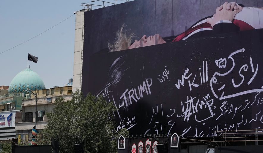 A billboard depicting U.S. President Donald Trump lying on what appears to be a coffin and bearing anti-Trump messages, including the phrase "We Kill Trump," is seen at Islamic Revolution Square in downtown Tehran, Iran, Wednesday, July 15, 2026. (AP Photo/Vahid Salemi)
