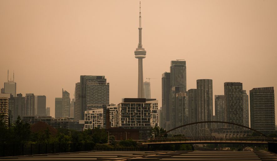 The CN Tower is pictured in Toronto as wildfire smoke fills the city, on Wednesday, July 15, 2026. (Laura Proctor/The Canadian Press via AP)