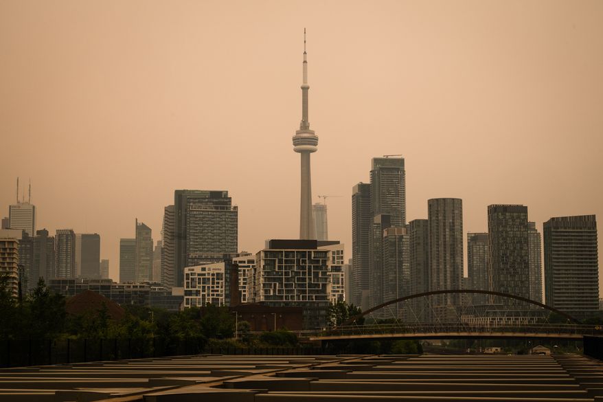 The CN Tower is pictured in Toronto as wildfire smoke fills the city, on Wednesday, July 15, 2026. (Laura Proctor/The Canadian Press via AP)