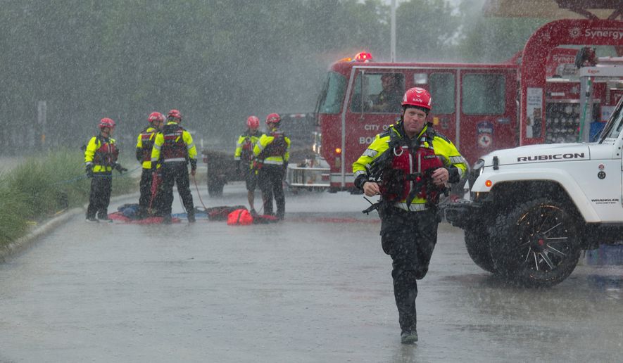 Members of the Boerne Fire Dept. prepare to perform a water rescue on Wednesday, July 15, 2026, in Boerne, Texas. (AP Photo/Darren Abate)