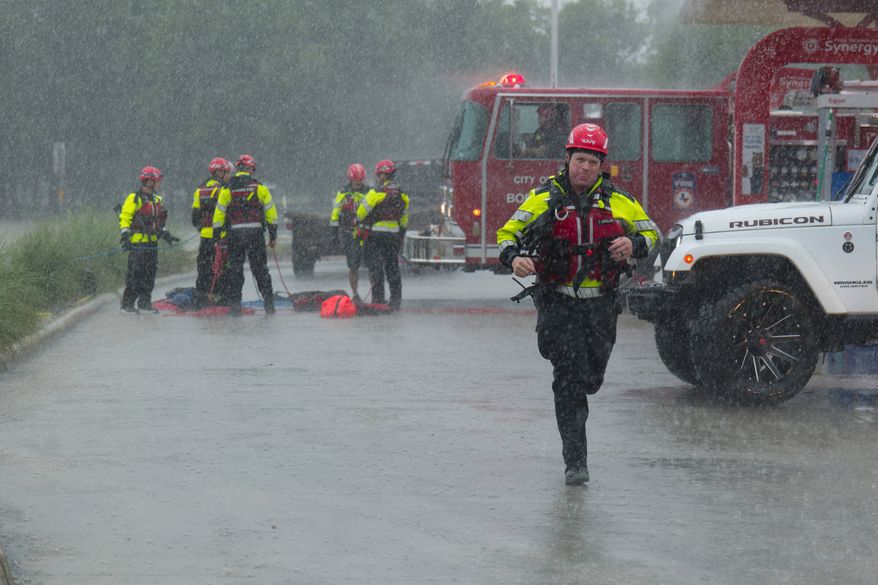 Members of the Boerne Fire Dept. prepare to perform a water rescue on Wednesday, July 15, 2026, in Boerne, Texas. (AP Photo/Darren Abate)