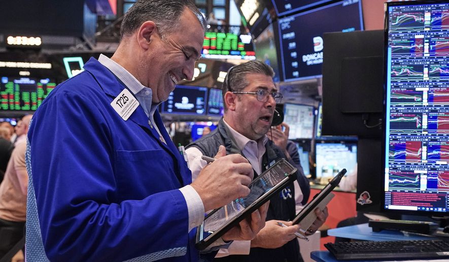Traders Chris Lagana, left, and Michael Capolino work on the floor of the New York Stock Exchange, Thursday, June 25, 2026. (AP Photo/Richard Drew)