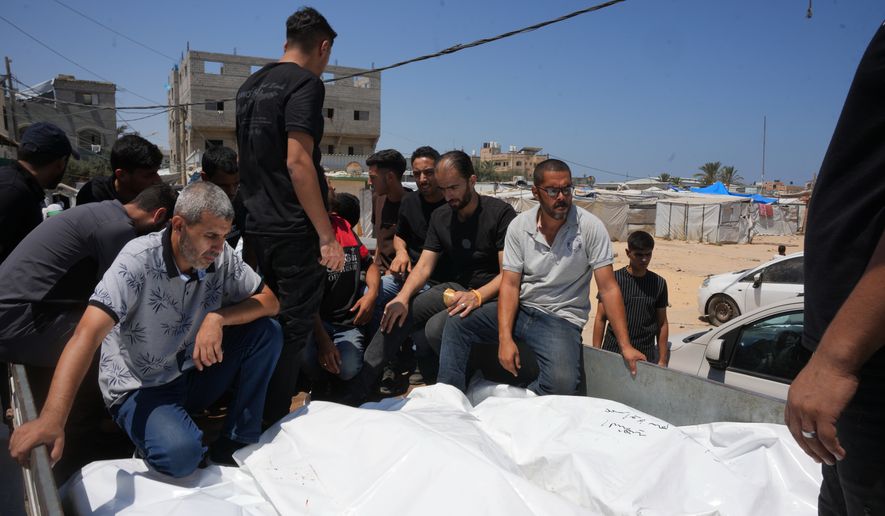 Palestinians carry the bodies of people killed in an Israeli military strike on a residential building on the back of a vehicle as they attend their funeral at Al-Aqsa Hospital in Deir al-Balah, central Gaza Strip, Wednesday, July 15, 2026.(AP Photo/Abdel Kareem Hana)