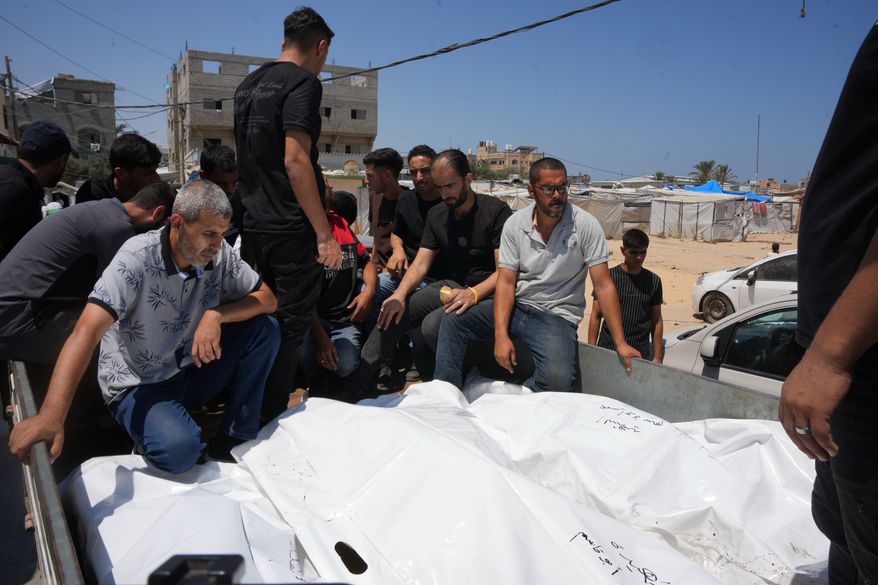 Palestinians carry the bodies of people killed in an Israeli military strike on a residential building on the back of a vehicle as they attend their funeral at Al-Aqsa Hospital in Deir al-Balah, central Gaza Strip, Wednesday, July 15, 2026.(AP Photo/Abdel Kareem Hana)