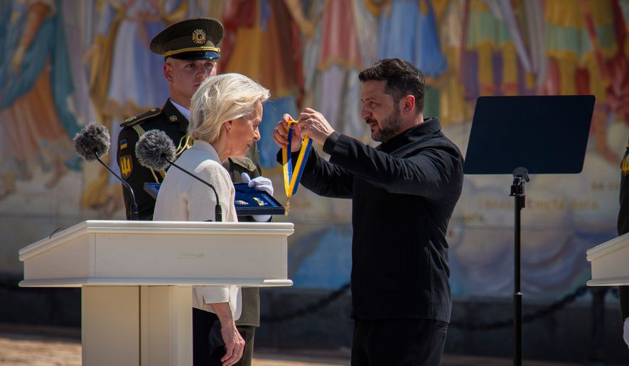 Ukrainian President Volodymyr Zelenskyy, right, awards European Commission President Ursula von der Leyen in Kyiv, Ukraine, Wednesday, July 15, 2026. (AP Photo/Dan Bashakov)
