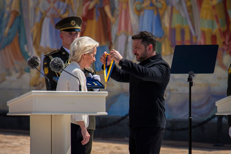 Ukrainian President Volodymyr Zelenskyy, right, awards European Commission President Ursula von der Leyen in Kyiv, Ukraine, Wednesday, July 15, 2026. (AP Photo/Dan Bashakov)