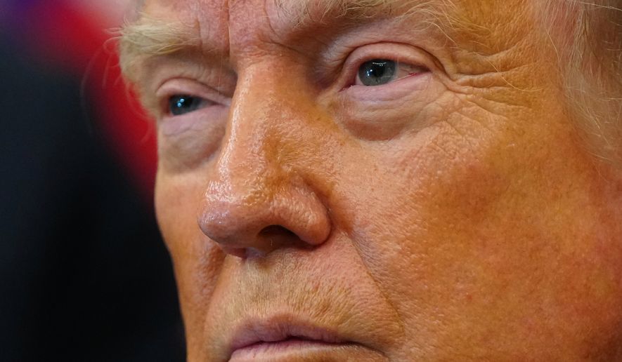 President Donald Trump listens after signing executive orders modifying the Bears Ears National Monument and the Grand Staircase-Escalante National Monument in the Oval Office of the White House, Monday, July 13, 2026, in Washington. (AP Photo/Julia Demaree Nikhinson)