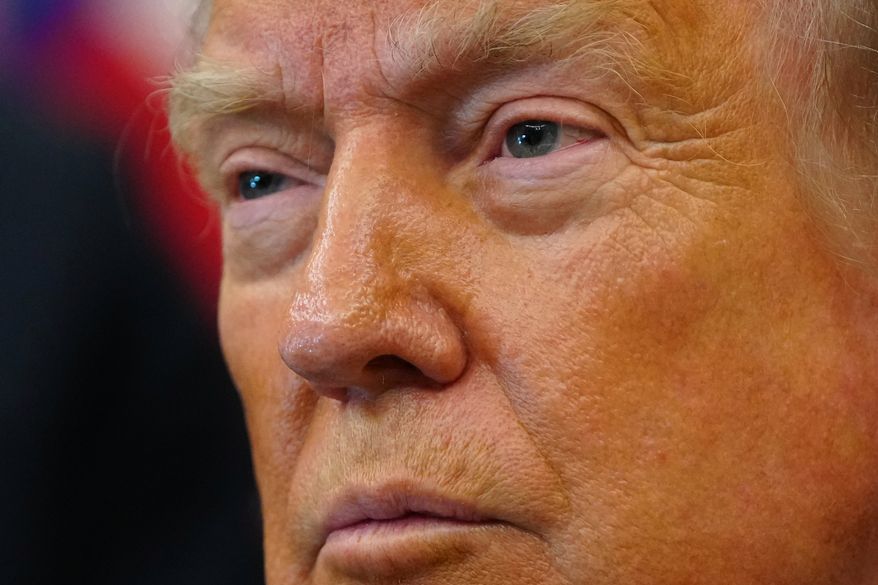 President Donald Trump listens after signing executive orders modifying the Bears Ears National Monument and the Grand Staircase-Escalante National Monument in the Oval Office of the White House, Monday, July 13, 2026, in Washington. (AP Photo/Julia Demaree Nikhinson)