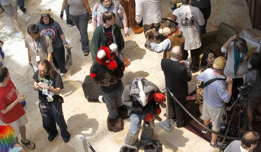 In this photo made on Thursday, June 14, 2012, people attending Anthrocon, some in animal costumes, greet and mingle in the lobby of the Westin Convention Center hotel in Pittsburgh. Anthrocon is the world's largest convention for people who dress and assume the rolls of fictional animal characters. (AP Photo/Keith Srakocic)