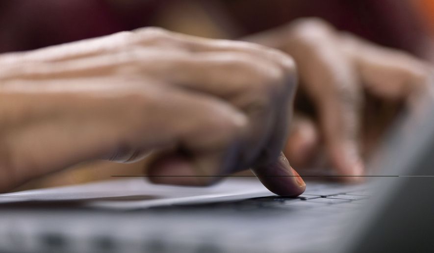 A person types during a keyboard basics class offered by Free Geek on Thursday, May 15, 2025, in Portland, Ore. (AP Photo/Jenny Kane)
