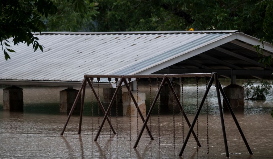 Water along the Pedernales River floods the Gillespie County Safety Rest Area on Thursday, July 16, 2026, in Stonewall, Texas. (AP Photo/Joel Angel Juarez)