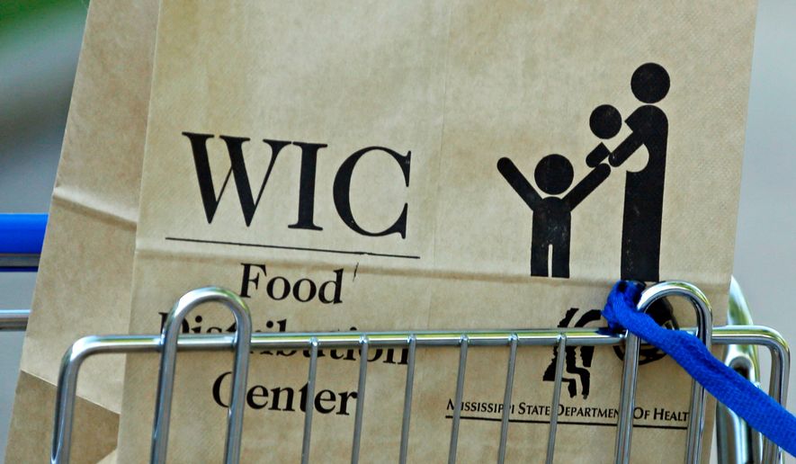 A Special Supplemental Nutrition Program for Women, Infants and Children, better known as WIC, bag sits in a shopping cart in Jackson, Miss., on Oct. 3, 2013. (AP Photo/Rogelio V. Solis) **FILE**