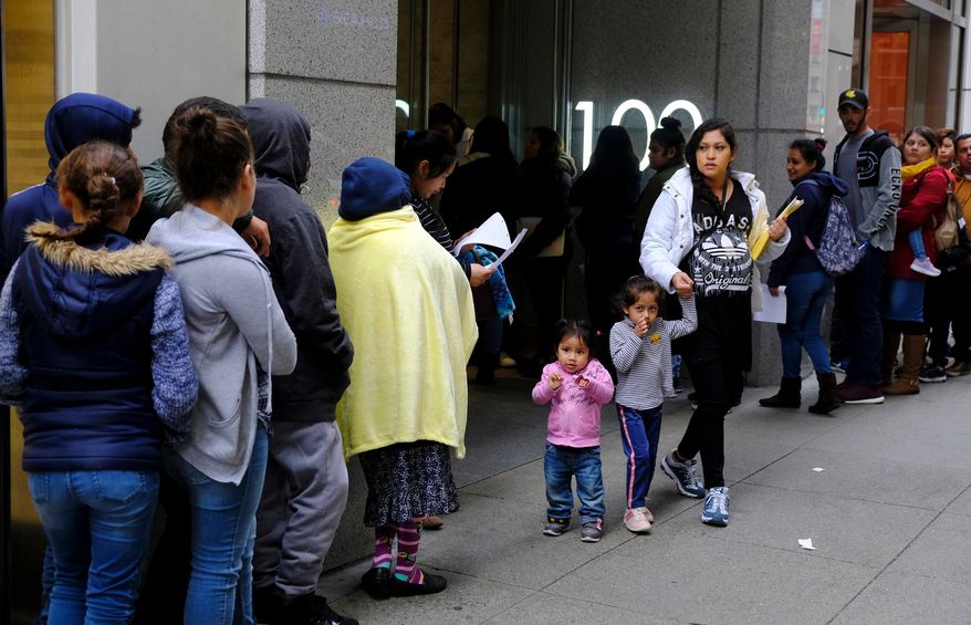 Hundreds of people stand in line outside a U.S. immigration office with numerous courtrooms in San Francisco on Jan. 31, 2019. (AP Photo/Eric Risberg) **FILE**