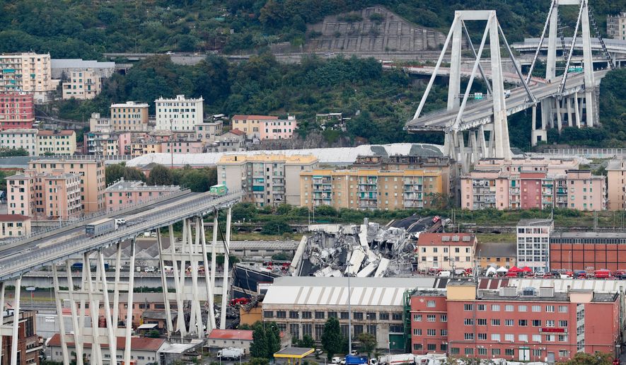 FILE - Cars are blocked on the Morandi highway bridge after a section of it collapsed, Aug. 14, 2018, in Genoa, northern Italy. (AP Photo/Antonio Calanni, File)