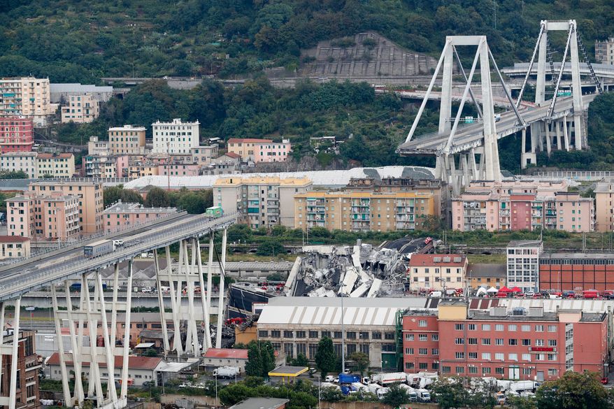 FILE - Cars are blocked on the Morandi highway bridge after a section of it collapsed, Aug. 14, 2018, in Genoa, northern Italy. (AP Photo/Antonio Calanni, File)