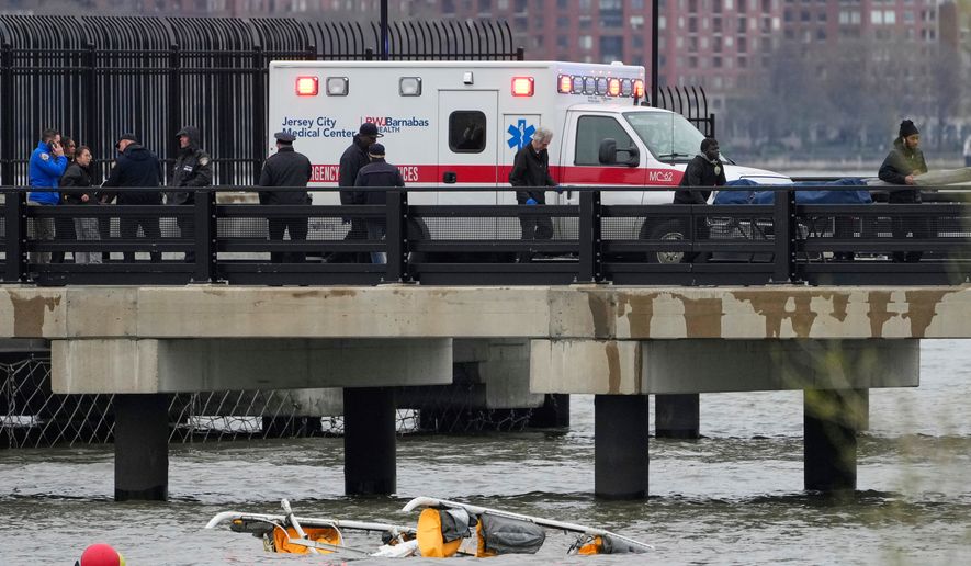 FILE - Emergency personnel respond to a helicopter crash on the Hudson River, April 10, 2025, in Jersey City, N.J. (AP Photo/Seth Wenig, File)