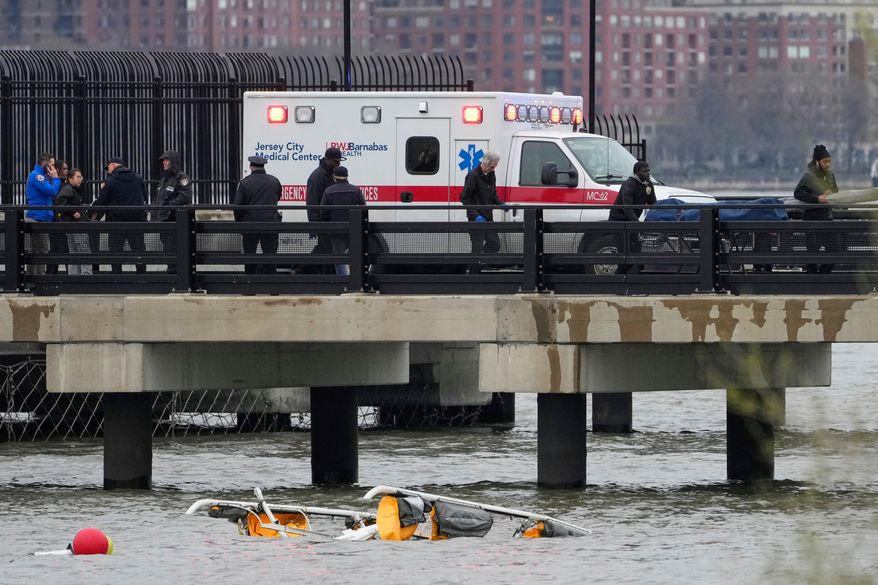 FILE - Emergency personnel respond to a helicopter crash on the Hudson River, April 10, 2025, in Jersey City, N.J. (AP Photo/Seth Wenig, File)