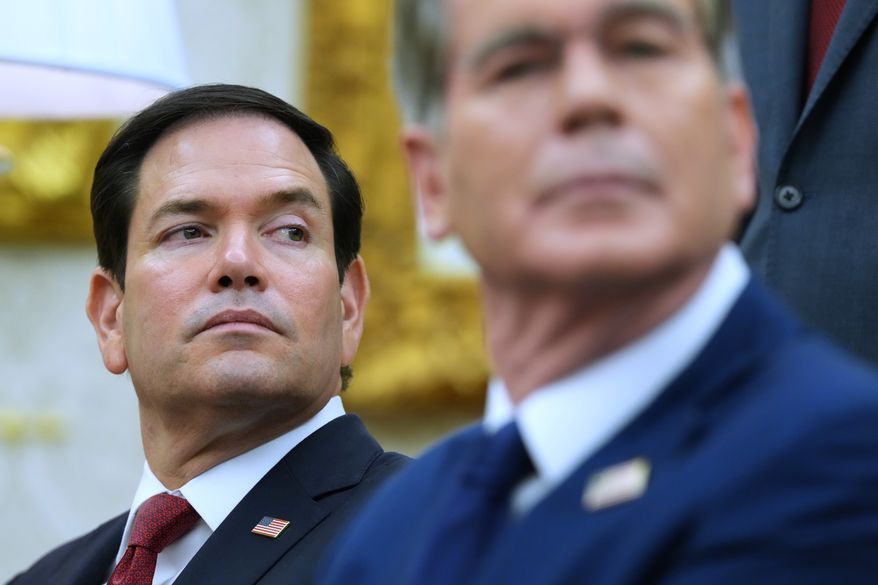 Secretary of State Marco Rubio, left, listen as President Donald Trump meets with Iraq's Prime Minister Ali al-Zaidi in the Oval Office of the White House, Tuesday, July 14, 2026, in Washington. (AP Photo/Julia Demaree Nikhinson)
