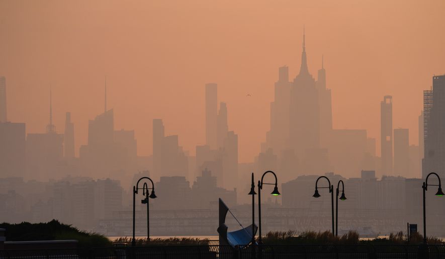 The New York City skyline is seen through a cover of wildfire smoke, in Jersey City, N.J., Friday, July 17, 2026. (AP Photo/Ryan Murphy)