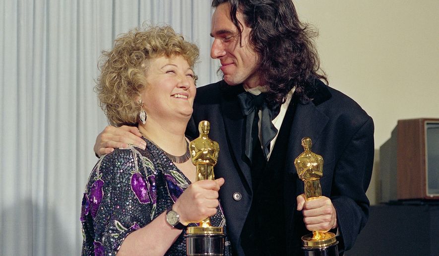 "My Left Foot" stars Brenda Fricker, winner of Oscar for best supporting actress, and Daniel Day Lewis, winner of Oscar for best actor, at the 62nd Annual Academy Awards in Los Angeles, March 26, 1990. (AP Photo/Bob Galbraith, File)