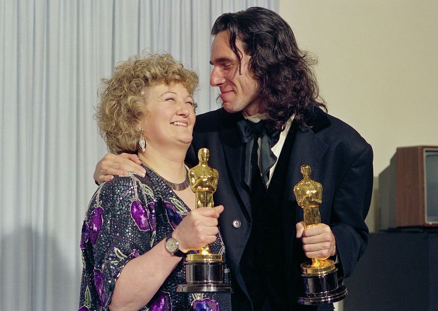 "My Left Foot" stars Brenda Fricker, winner of Oscar for best supporting actress, and Daniel Day Lewis, winner of Oscar for best actor, at the 62nd Annual Academy Awards in Los Angeles, March 26, 1990. (AP Photo/Bob Galbraith, File)