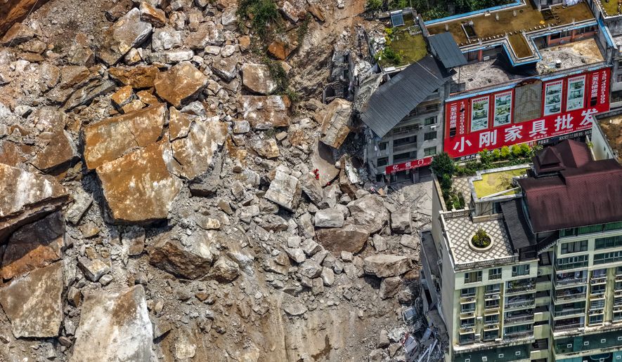 In this photo released by Xinhua News Agency, rescuers conduct search and rescue operation on the site of the landslide in Pengshui County in southwestern China's Chongqing on Friday, July 17, 2026. (Huang Wei/Xinhua via AP)