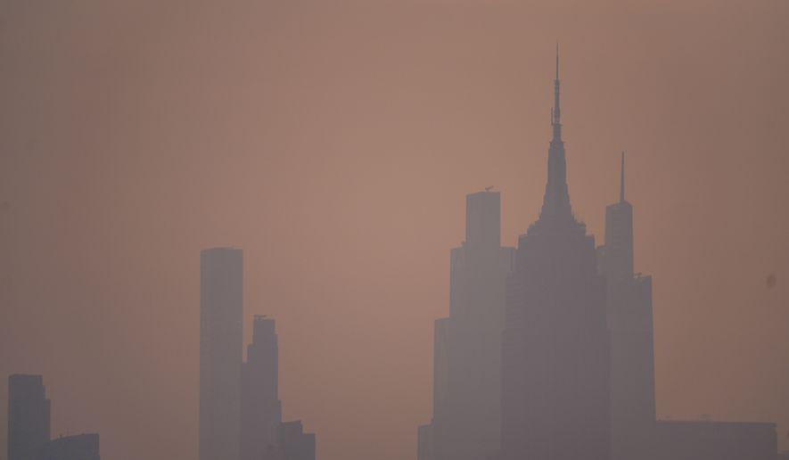 The New York City skyline is seen through a cover of wildfire smoke, in Jersey City, N.J., Friday, July 17, 2026. (AP Photo/Ryan Murphy)