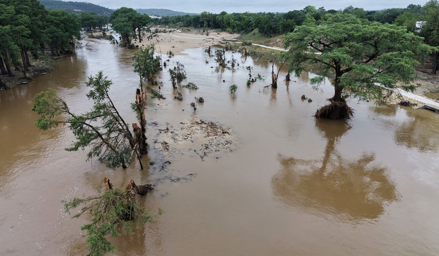 An aerial view shows the Guadalupe River after a series of storms Friday, July 17, 2026, in Kerrville, Texas. (AP Photo/Gerald Herbert)