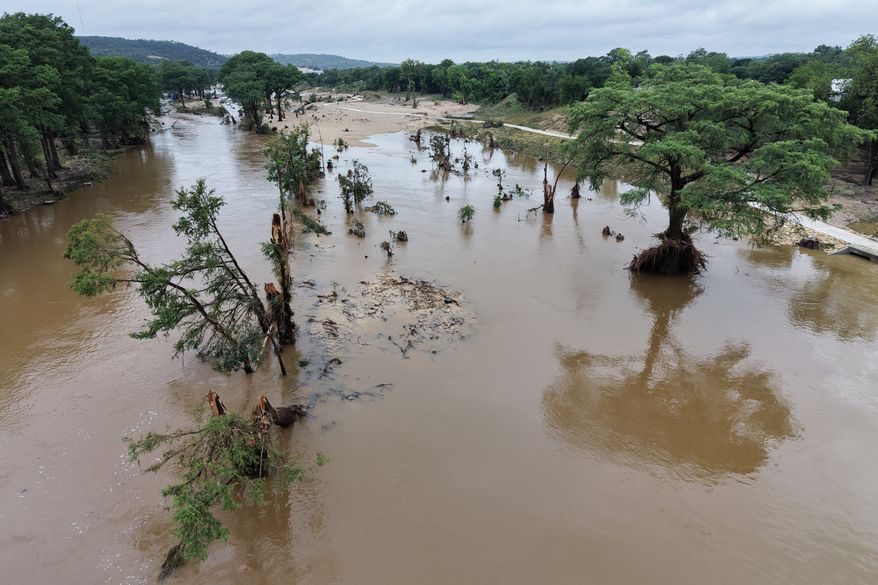 An aerial view shows the Guadalupe River after a series of storms Friday, July 17, 2026, in Kerrville, Texas. (AP Photo/Gerald Herbert)