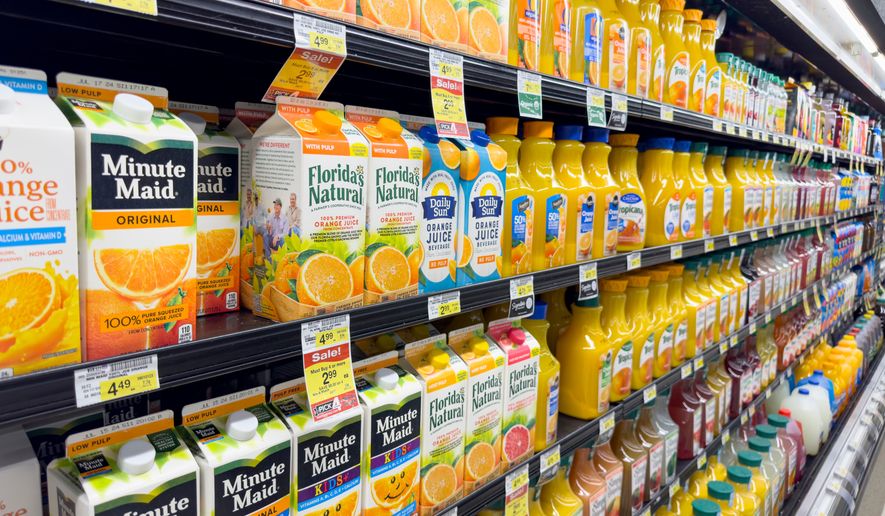 A view of several shelves dedicated to brands of orange juice on display at a local grocery store. File photo credit: The Image Party via Shutterstock.