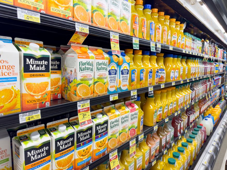 A view of several shelves dedicated to brands of orange juice on display at a local grocery store. File photo credit: The Image Party via Shutterstock.