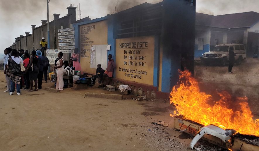 Rubble set on fire as health workers involved in Congo's Ebola response go on strike as they protest over payment issues in Bunia, Congo, Wednesday, July 15, 2026. (AP Photo/Constant Same Bagalwa)
