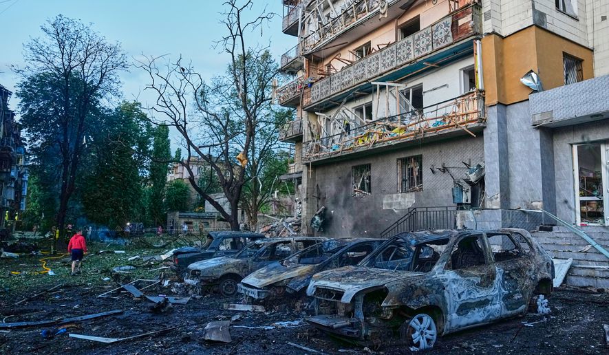 Local residents wander among debris following a Russia missile attack in Kyiv, Ukraine, Sunday, July 19, 2026. (AP Photo/Efrem Lukatsky)