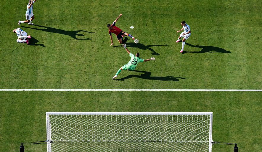 Spain's Mikel Merino (6) tries to score past Argentina goalkeeper Emiliano Martinez (23) as Argentina's Nicolas Otamendi (19), left, and Argentina's Facundo Medina (25), top left, react during the World Cup final soccer match between Spain and Argentina in East Rutherford, N.J., near New York, Sunday, July 19, 2026. (AP Photo/Matt Slocum)
