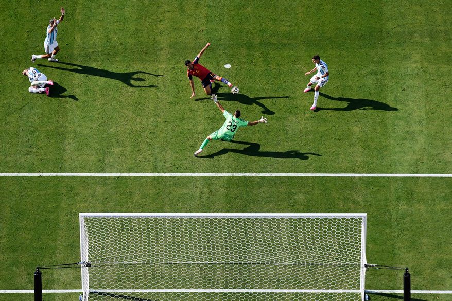 Spain's Mikel Merino (6) tries to score past Argentina goalkeeper Emiliano Martinez (23) as Argentina's Nicolas Otamendi (19), left, and Argentina's Facundo Medina (25), top left, react during the World Cup final soccer match between Spain and Argentina in East Rutherford, N.J., near New York, Sunday, July 19, 2026. (AP Photo/Matt Slocum)