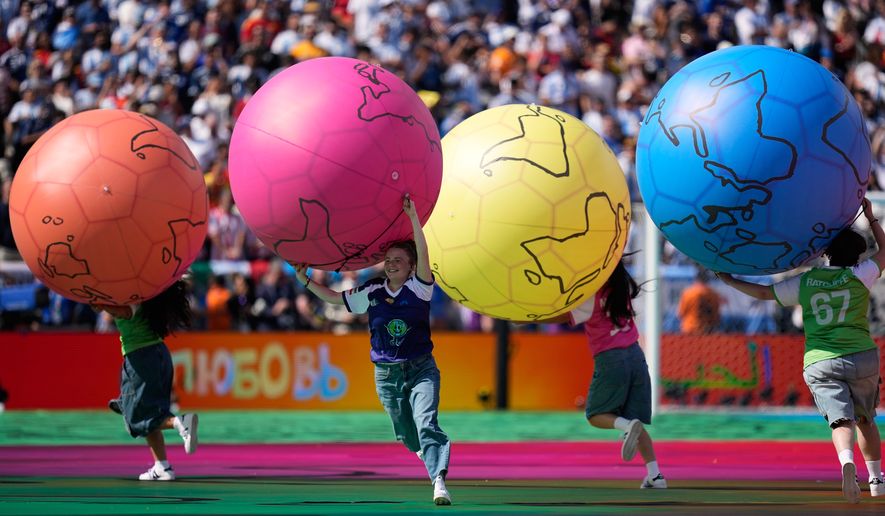 Children run on the pitch during the halftime show of during the World Cup final soccer match between Spain and Argentina in East Rutherford, N.J., near New York, Sunday, July 19, 2026. (AP Photo/Ashley Landis)