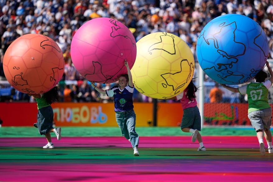 Children run on the pitch during the halftime show of during the World Cup final soccer match between Spain and Argentina in East Rutherford, N.J., near New York, Sunday, July 19, 2026. (AP Photo/Ashley Landis)