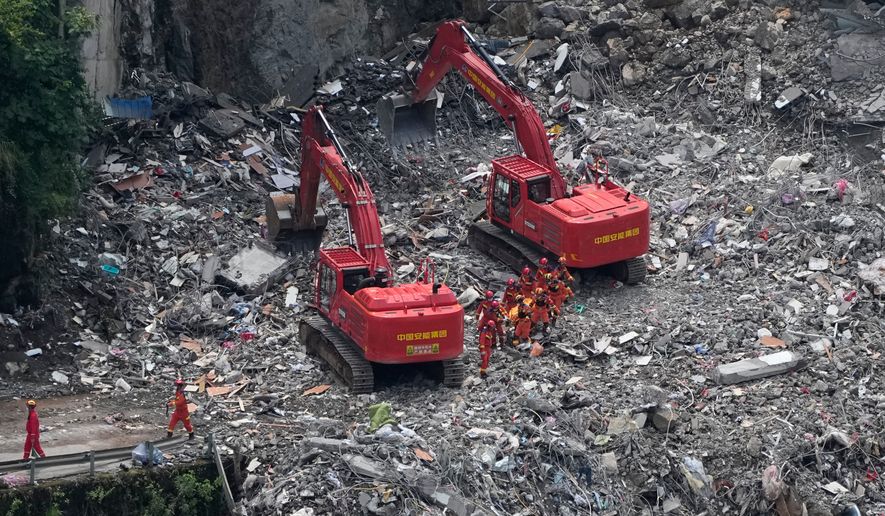 Rescuers work at the site of a landslide in Pengshui County in southwestern China's Chongqing on Sunday, July 19, 2026. (AP Photo/Andy Wong)